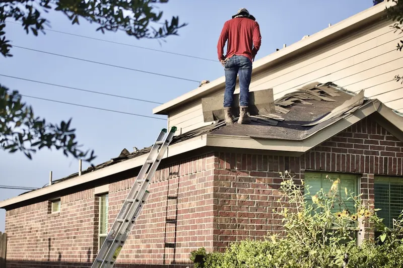 Professional roofer working on a residential roof in Rovey Farm Estates
